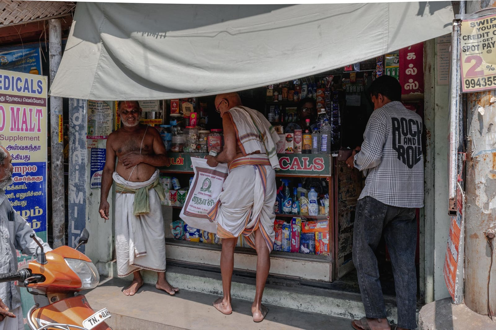 Neighbours at a local shop in Tiruchirappalli, Tamil Nadu.